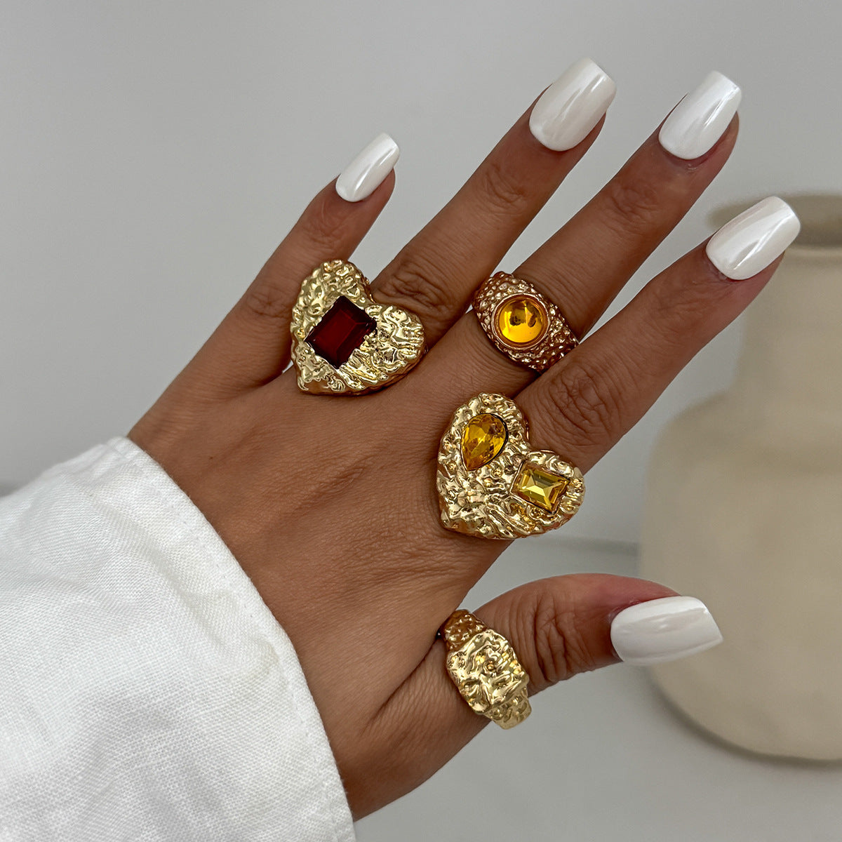 Instagram-worthy metallic lava heart-shaped ring with a design featuring square diamonds and a knuckle setting.