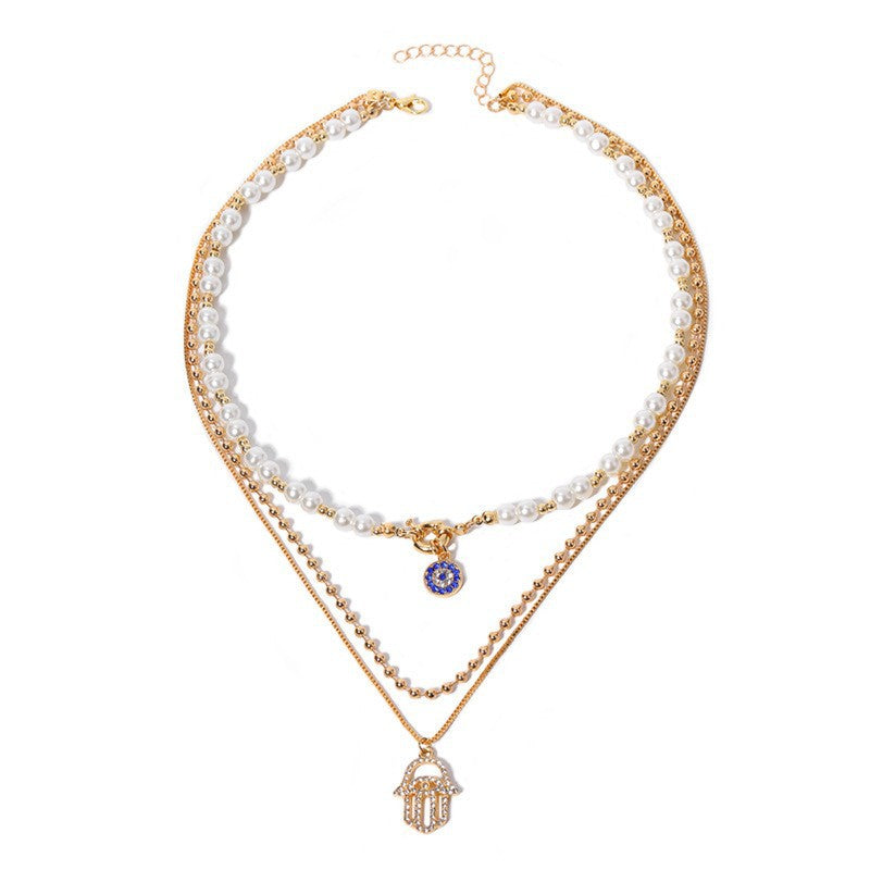 Elegant Layered Pearl Necklace with Evil Eye & Hamsa Charm – Chic and Protective
