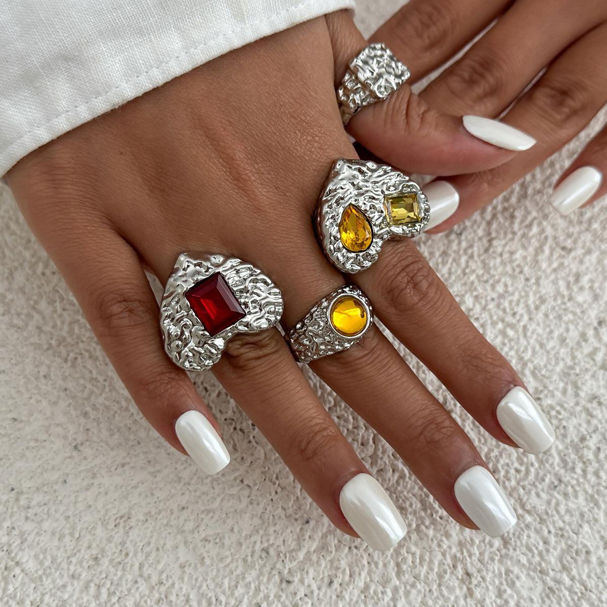 Instagram-worthy metallic lava heart-shaped ring with a design featuring square diamonds and a knuckle setting.