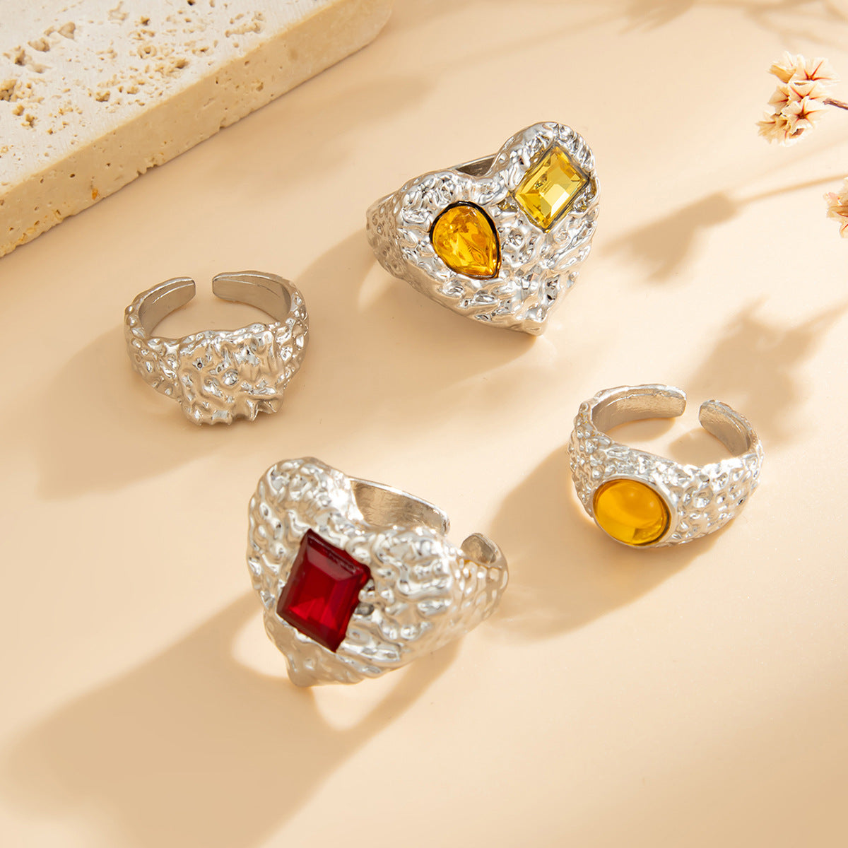 Instagram-worthy metallic lava heart-shaped ring with a design featuring square diamonds and a knuckle setting.