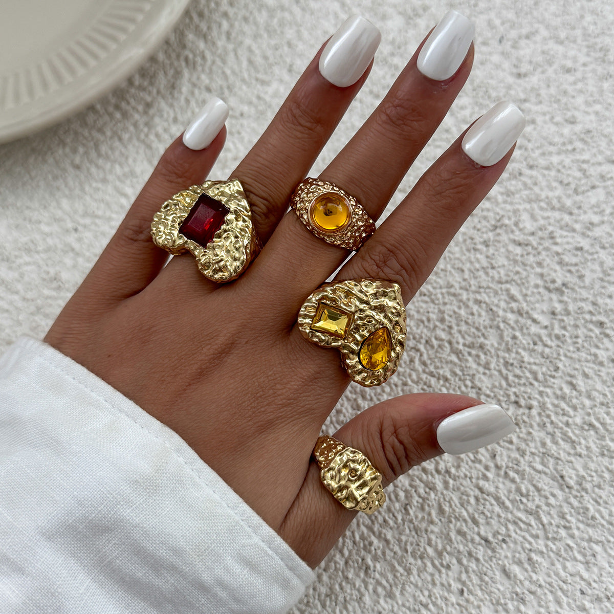 Instagram-worthy metallic lava heart-shaped ring with a design featuring square diamonds and a knuckle setting.